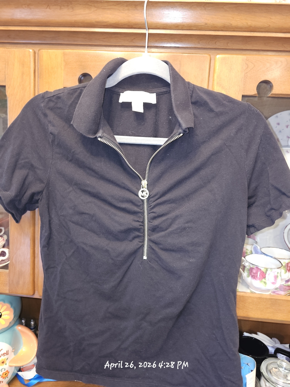 Michael Kors ruched zip polo top featuring a distinct front zipper with logo